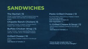 Sandwiches portion of the menu including rachel sandwhich, chipotle chicken ranch, buffalo chicken wrap, grilled cheese, pesto grilled cheese, and 1/2 grilled cheese 1/2 soup. 