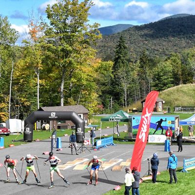 An aerial view of a roller ski race in the stadium at mt van hoevenberg.